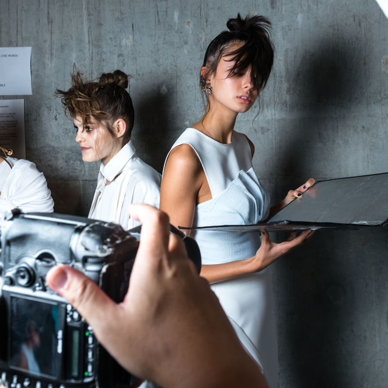 View of a camera screen as it takes a photo of two people modeling white clothing